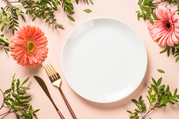 istock Table setting with white plate, cutlery and flowers. 1680723290