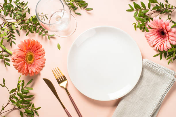 istock Table setting with white plate, cutlery and flowers. 1680724884