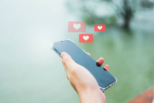 A man sends a Valentine's Day text message on his phone and socializes through the internet - social networking, technology, and life