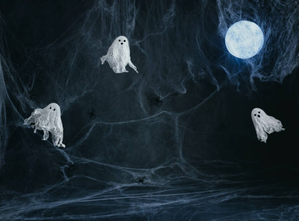 istock Halloween dark background with ghosts, glowing moon and a spider web with a copy space. Image for montage or display your products. Ghosts made of gauze and starch. Halloween decor. 1680742701