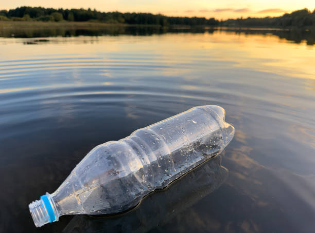 istock Plastic bottle garbage on sea shore lake. Collecting waste and garbage on beach. 1680743747