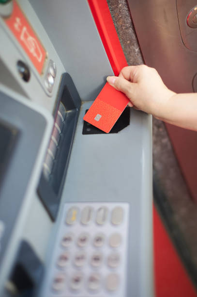 istock Unrecognizable woman's hand using your credit card at an ATM in selective focus 1680759954