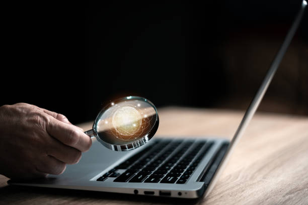 istock Man holds a magnifying glass searching for things on the virtual world icon. Search technology concept, internet search. 1680762052