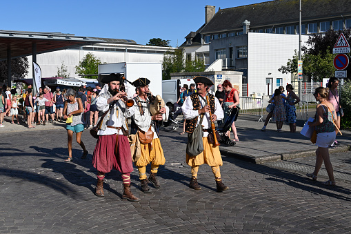 Erquy, Brittany, France, August 21, 2023 - Traditional Breton musicians at the summer market / evening market in downtown Erquy, Brittany.