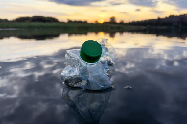 istock Marine plastic pollution. Plastic waste in lake water. 1680778612