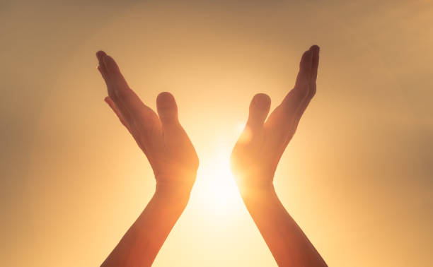 istock Woman hands holding the sun at dawn. 1680780217