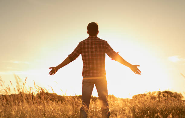 istock Young man facing sunset rejoices, enjoys life, happiness. 1680793064