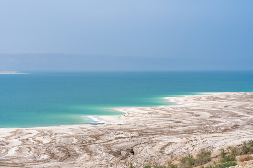 Desert landscape of Dead Sea coastline with white salt in Jordan. Travel destinations
