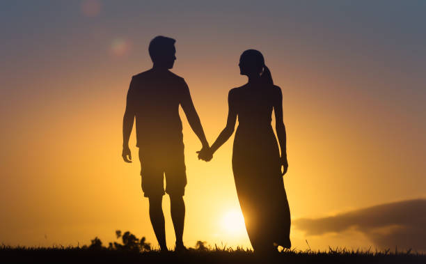istock Couple walking towards beautiful sunset. 1680811447