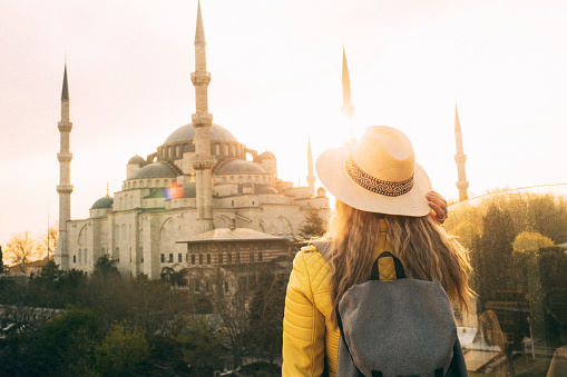 Young beautiful girl traveler in a hat with a backpack in İstanbul, İstanbul, Türkiye