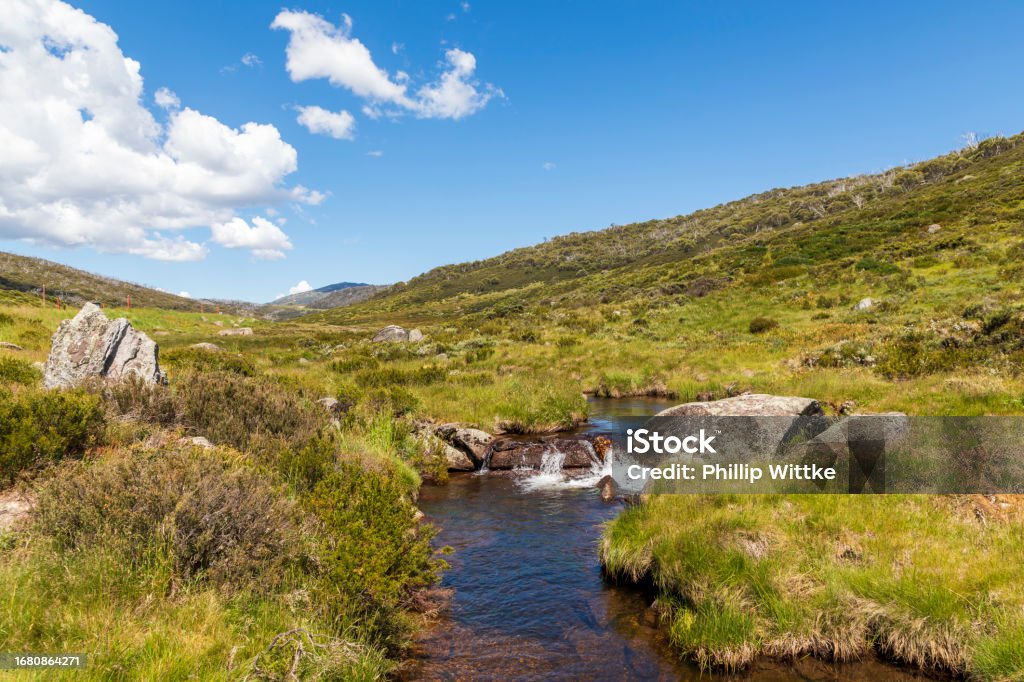 Photograph of a fresh water creek flowing through a valley in the Snowy Mountains in New South Wales in Australia Kosciuszko National Park Stock Photo