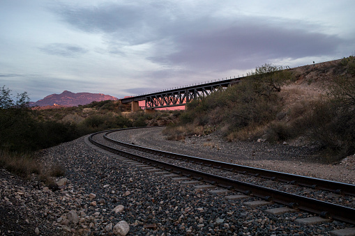 Train bridge going over train tracks at sunset in Vail, Arizona, United States