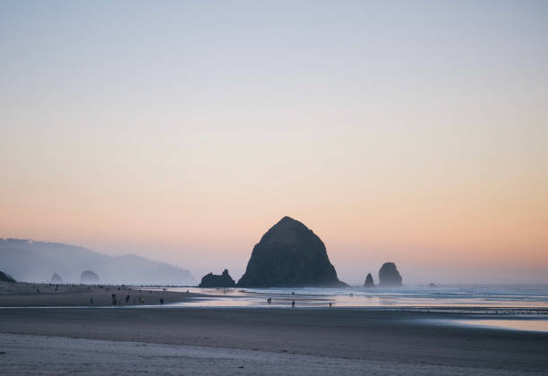 istock Haystack Rock At Sunset on Cannon Beach, Oregon 1680875878