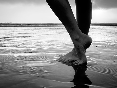 Black and White feet at the beach in Pismo Beach, California, United States