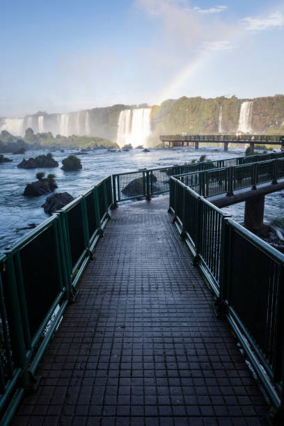 Beautiful view to catwalk for tourists over waterfalls in Iguassu Beautiful view to catwalk for tourists over waterfalls in Iguassu in Foz do Iguaçu, State of Paraná, Brazil devils throat stock pictures, royalty-free photos & images