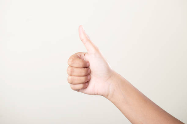 istock Female hand thumbsup on grey background 1680879392
