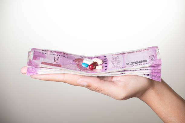 istock Medicine with indian currency in hand on grey background 1680880838