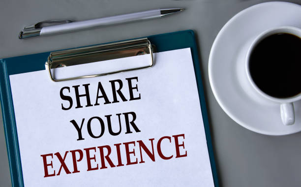 istock SHARE YOUR EXPERIENCE - words on a white sheet on a gray background with a pen and a cup of coffee 1680886367