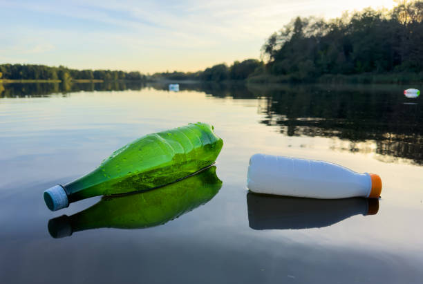 istock Plastic bottle garbage on sea shore lake. Collecting waste and garbage on beach. 1680892394