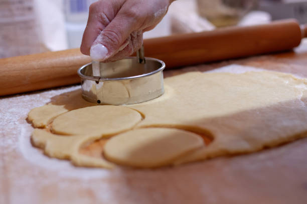 istock A woman's hand tearing the dough. 1680893977