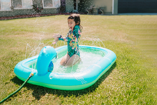 Toddler Girl Playing In Yard Pool in Huntington Beach, California, United States