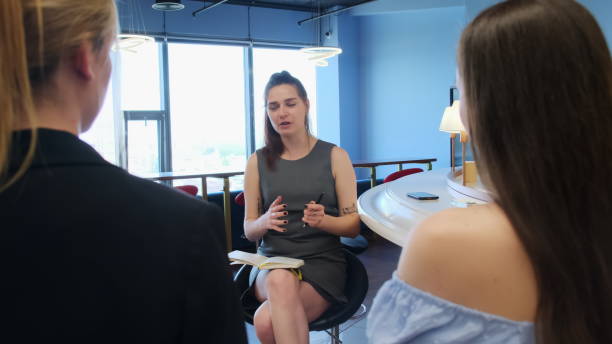 istock Young woman discuss work plan with colleagues ar lounge 1680898343