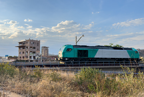 Diesel locomotive on the railroad against the backdrop. Freight train on railway in Spain