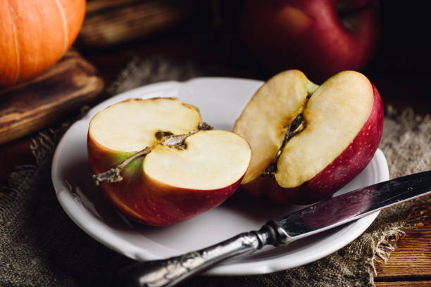 istock Two Halves of Red Apple on White Plate 1680928014