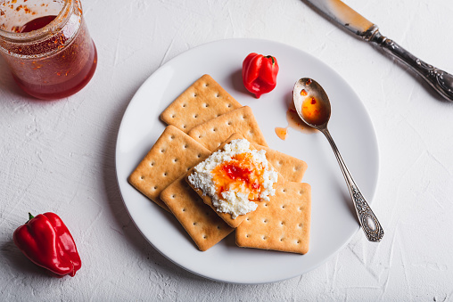 Crackers with Red Habanero Pepper Jam and Ricotta Cheese