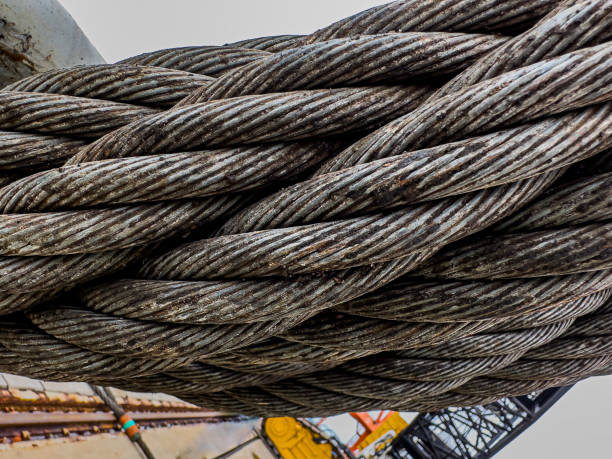 The steel metal cable closed up. Industrial twisted metal tow cable for heavy vehicles or machinery.