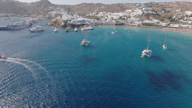 Aerial video of the coastline with hotels and yachts moored off the coast of Mykonos