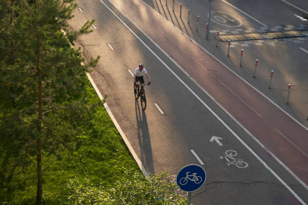 Man bicycling on cycling road. Top aerial view. Man bicycling on cycling road. Concept of active lifestyle. Top aerial view. top view on people walking and cyclists riding stock pictures, royalty-free photos & images