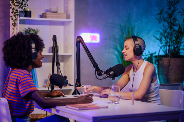 istock An interviewer is sitting across the table with a podcast guest 1681036185