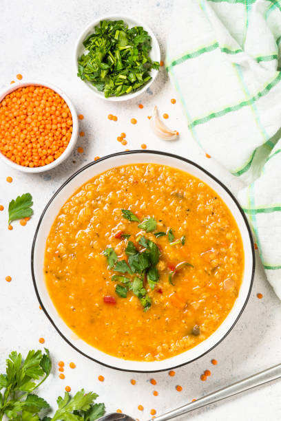 istock Lentil soup with vegetables at white stone table. 1681084246