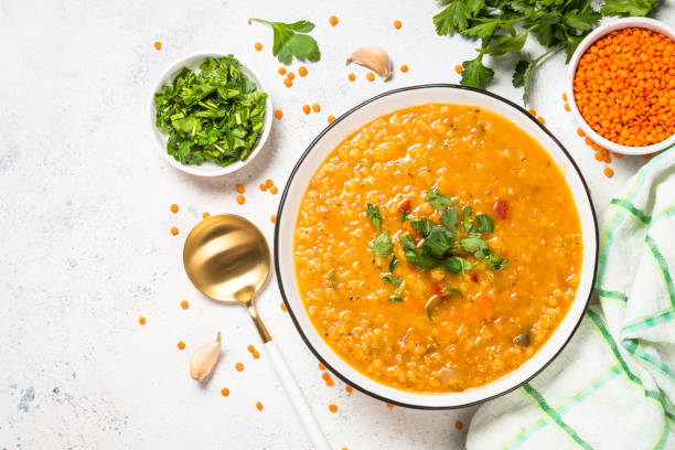istock Lentil soup with vegetables at white stone table. 1681084251