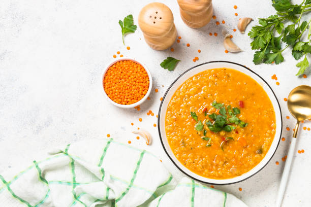 istock Lentil soup with vegetables at white stone table. 1681084255