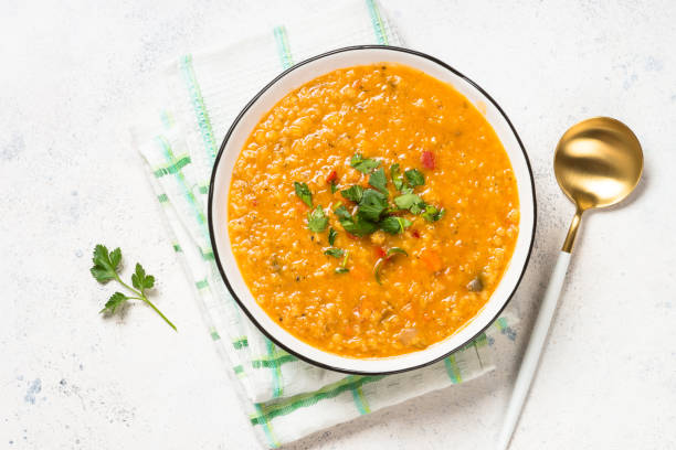 istock Lentil soup with vegetables at white stone table. 1681084384