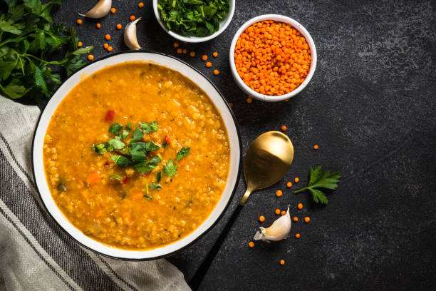 istock Lentil soup with vegetables on black stone table. 1681084549