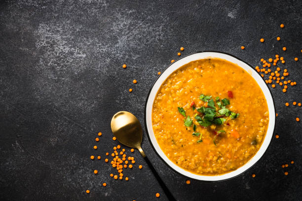 istock Lentil soup with vegetables on black stone table. 1681084839