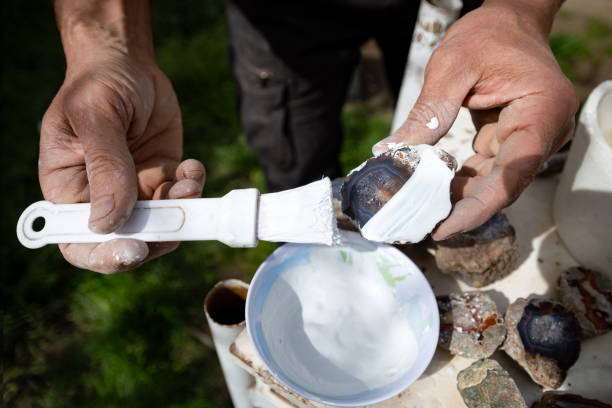 istock Craftsman putting aluminum oxide paste on agate to polish it. 1681091765