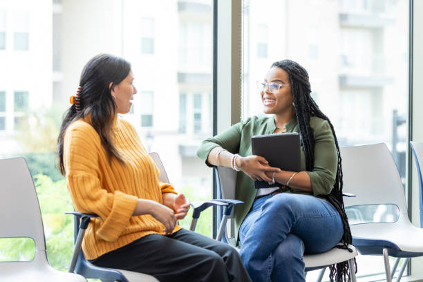 istock Female therapist listens to patient during therapy session 1681105201