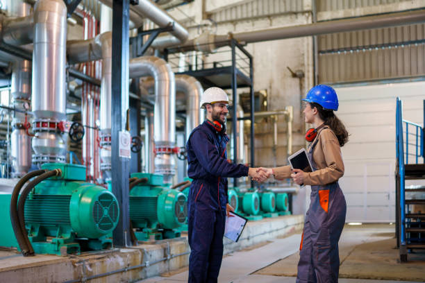 istock Young Workers Utilize Tablet and Folder to Improve Productivity at Heating Plant 1681109503