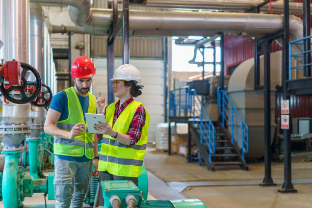 istock Pair of Workers at Heating Plant Use Digital Tablet for Task Management 1681115383