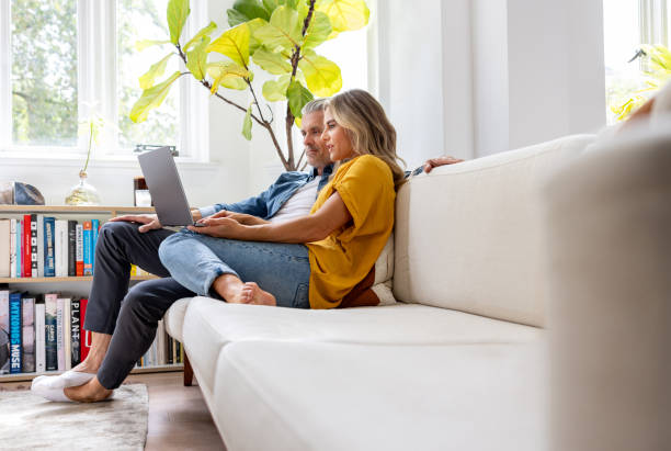 Couple at home booking a reservation online