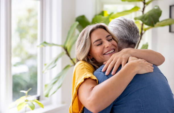istock Loving woman hugging her husband at home 1681118668