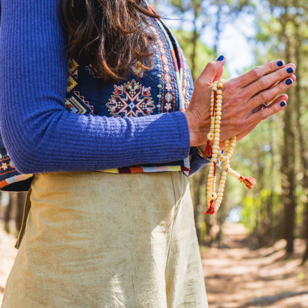 istock Close up of clasping hands holding a japa mala. 1681165192