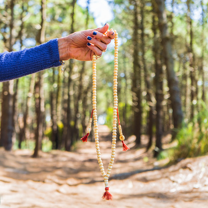 Close up of a japa mala over nature bakcground.