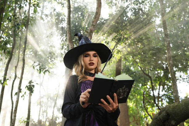 istock Witch pray the magic book in forest , Halloween concept 1681188731