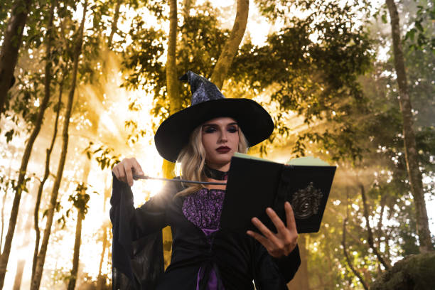 istock Witch pray the magic book in forest , Halloween concept 1681189121