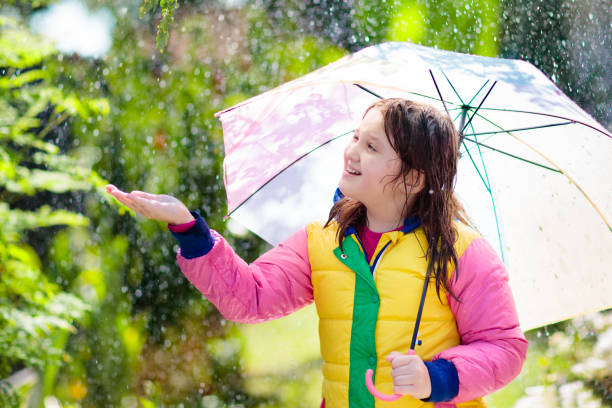 istock Child playing in autumn rain. Kid with umbrella. 1681207315